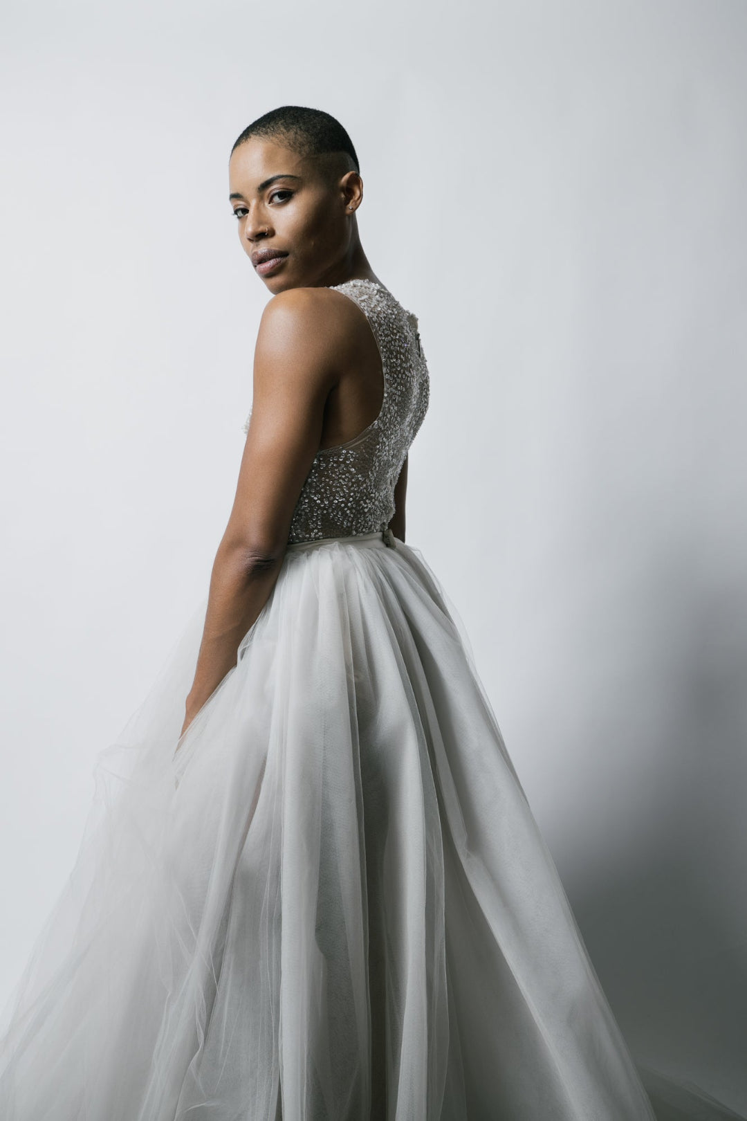 Model in a Priscilla Couture beaded body suit and white bridal tulle long skirt