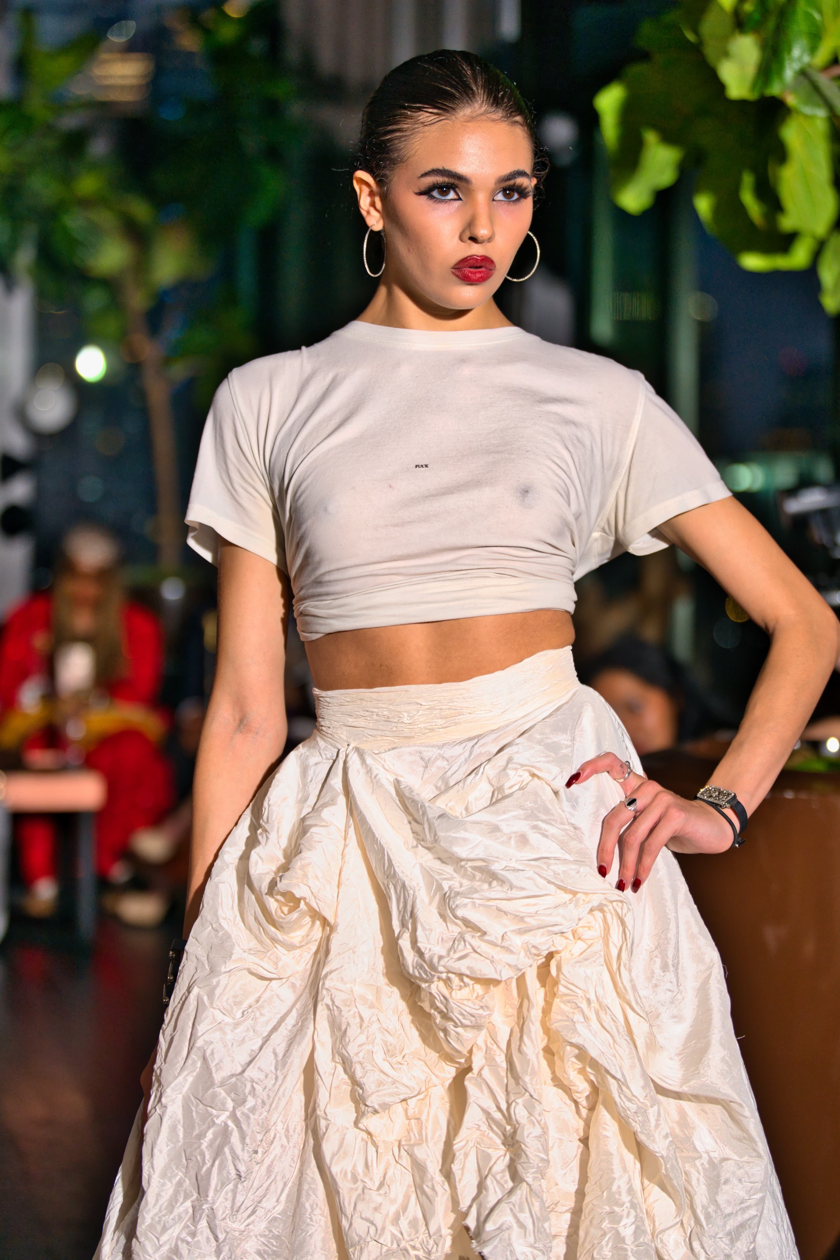 Woman in a white F tee  posing 