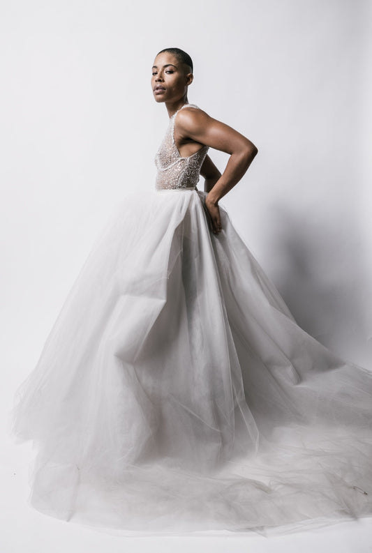 Model in a Priscilla Couture beaded body suit and white bridal tulle long skirt
