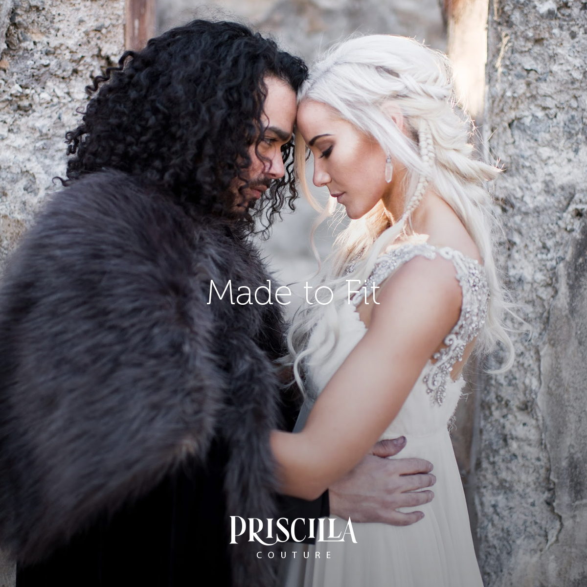 Bride and Groom in a Game of Thrones theme wedding embracing each other. Bride dressed in a Priscilla Couture wedding dress.