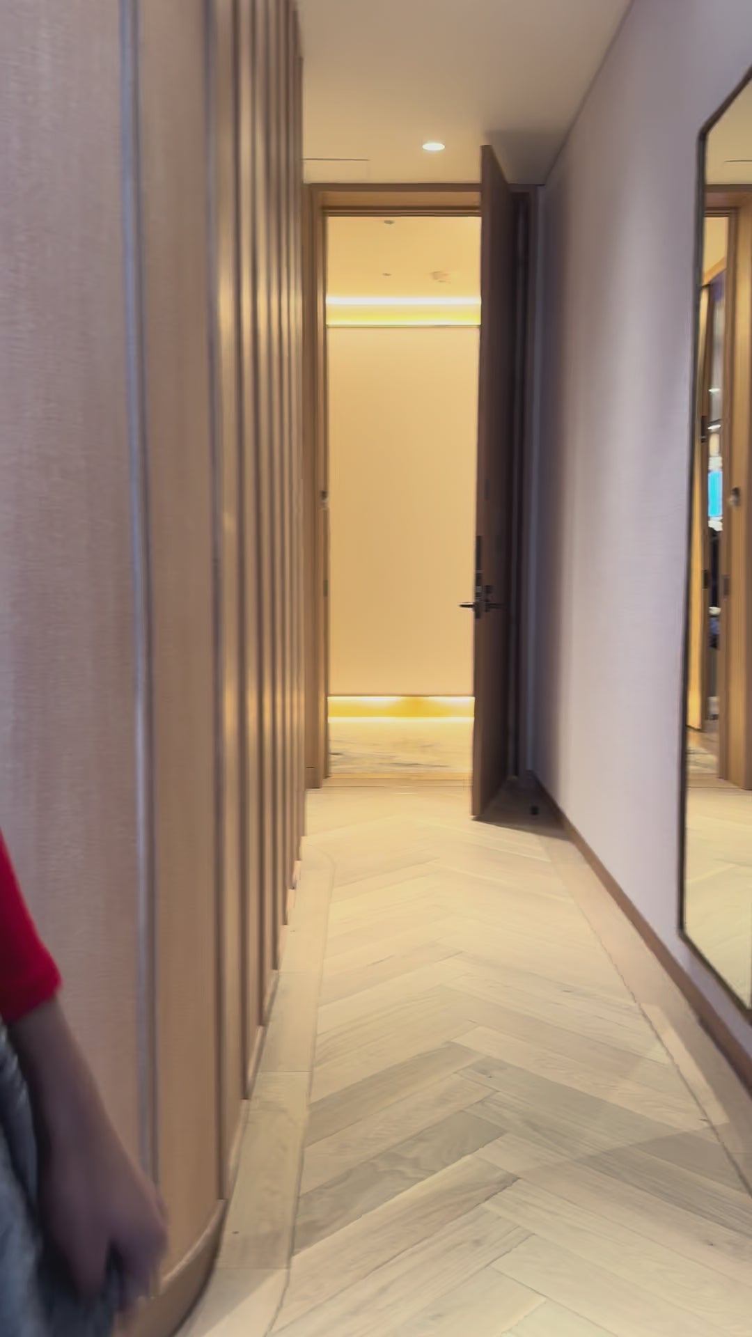 Priscilla Couture fashion model in a grey floral bridal skirt walking a hallway.