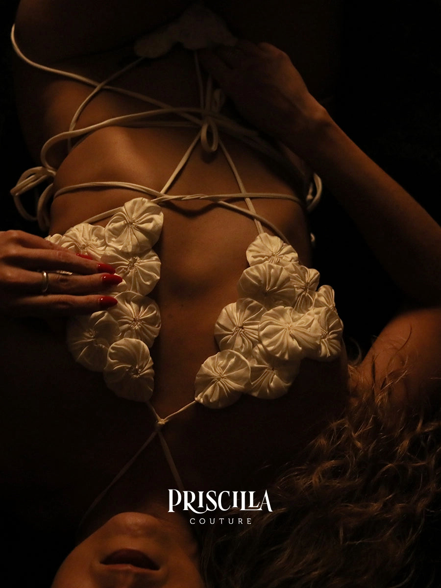 Close-up of a floral lingerie top with 'Priscilla Couture' branding.