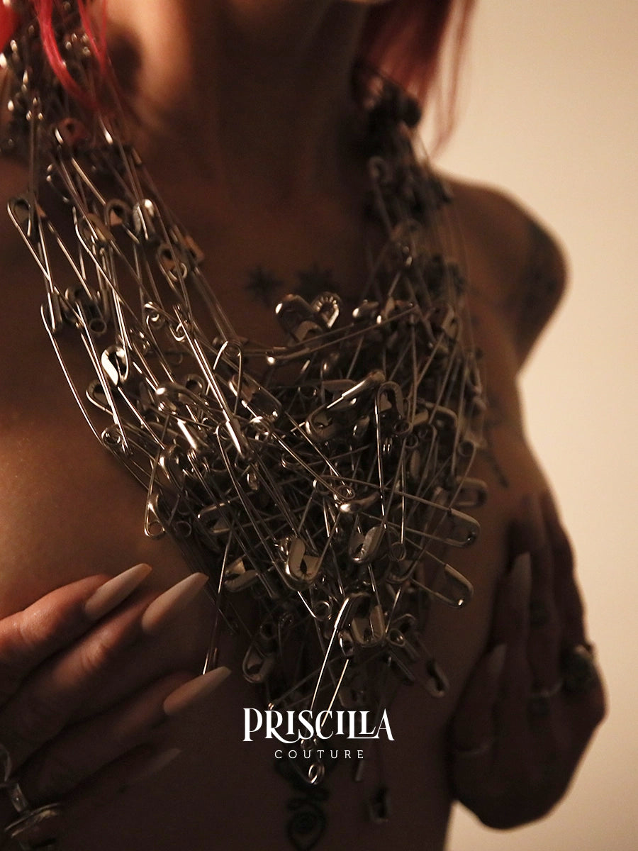 Priscilla Couture Connect Necklace with safety pins worn by a model, with 'Priscilla Couture' branding.