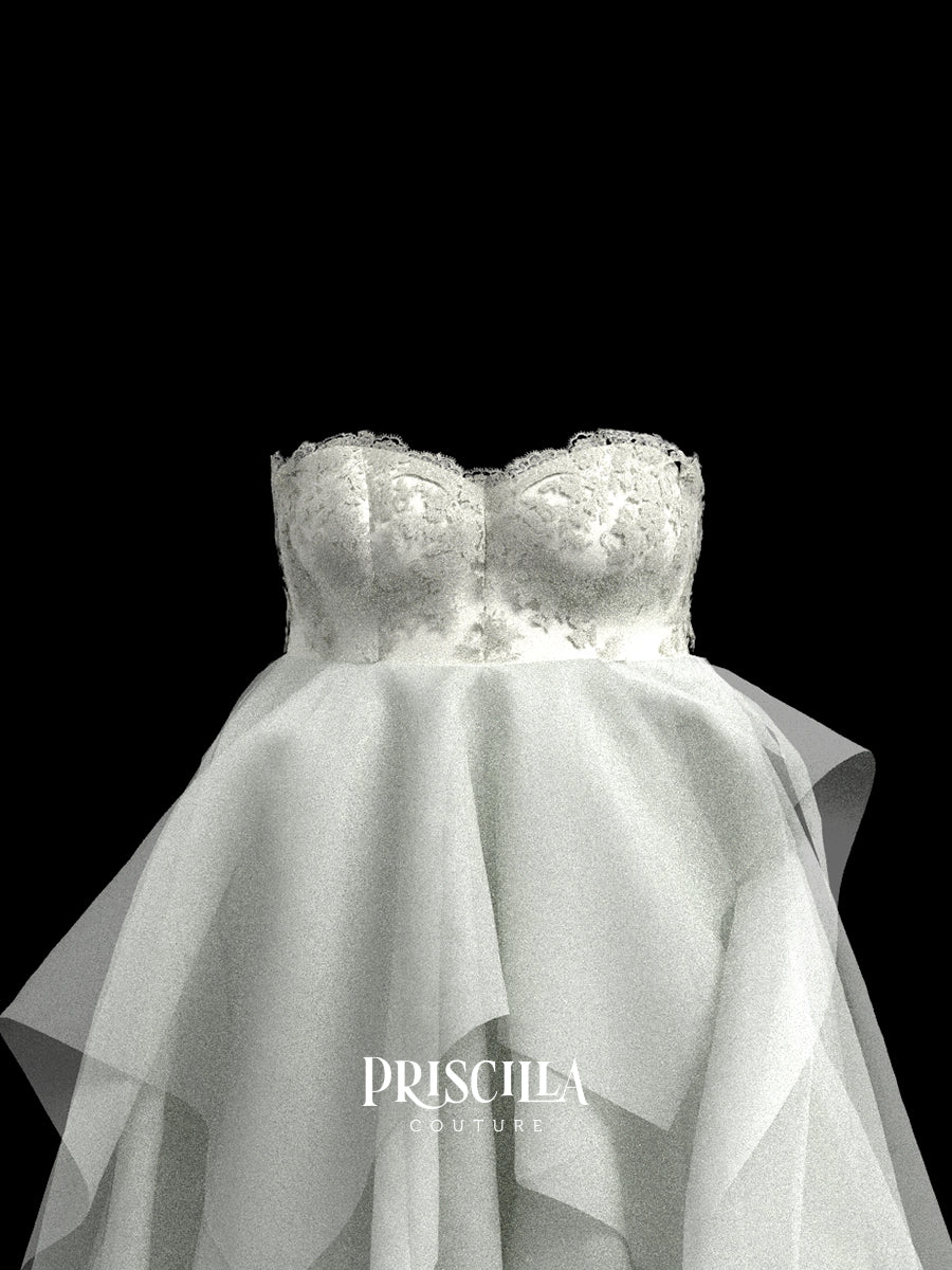 White Priscilla Couture custom strapless wedding dress 3D avatar with a lace-embroidered sweetheart bodice and layered tulle skirt, shown against a solid black background with the brand name Priscilla Couture overlaid at the bottom.