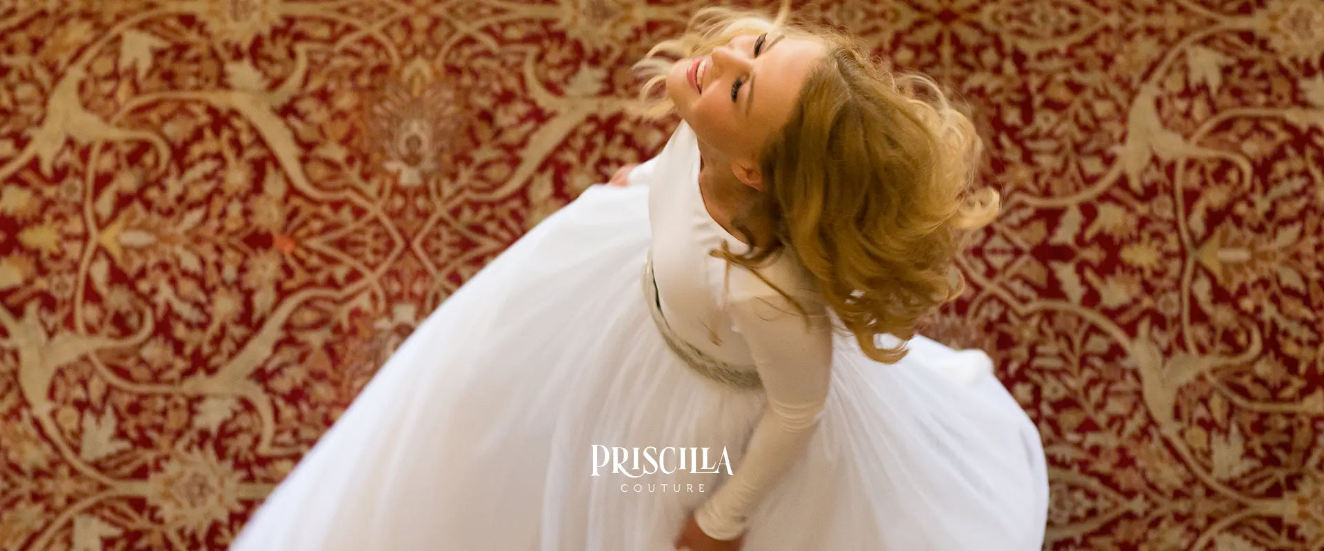 Top view of a bride in a Priscilla Couture wedding white tulle skirt with 'Priscilla Couture' branding.